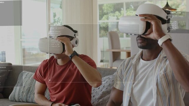 Two men putting on white VR headsets on couch, activating HUD overlays and navigating gaming menus