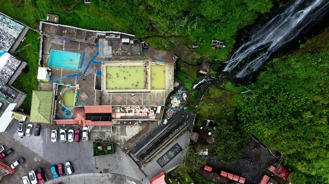 Banos, Ecuador: 10-11-2022: Aerial top down view of the thermal swimming pools in Banos de Agua santa a popular tourist destination in Ecuador, South America