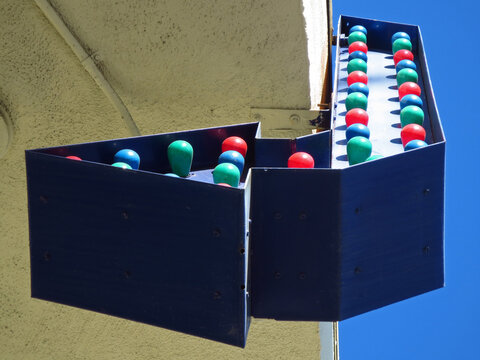 Retro Arrow Sign with Colorful Bulbs in Daylight