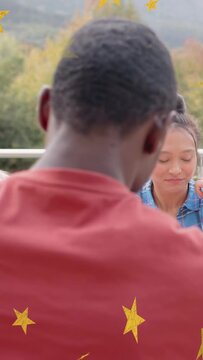Vertical video: Left woman talking cam panning showing woman sipping juice laughing stars over ads