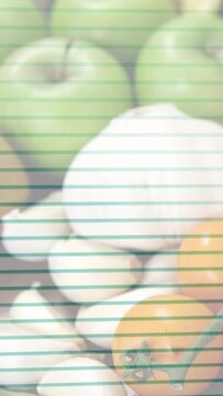 Vertical video: On pan, camera shifting down right, revealing apples to broccoli, showing produce
