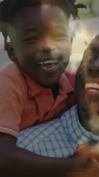 Vertical video: Father carrying son on back, laughing and shifting, causing AR hearts for family ad