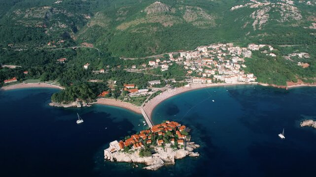 Luxurious villas on island shore. Scenic aerial perspective of exclusive resort island and surrounding waters