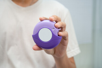 Fototapeta premium Asthma and chronic obstructive pulmonary disease COPD, Asian young man using metered dose inhaler MDI.