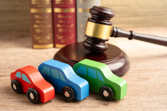 Hammer gavel judge with car vehicle accident, insurance coverage claim lawsuit court case.