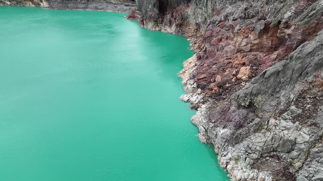 Stunning Aerial View of Earth's Natural Beauty: Volcanic Acid Lake and Rugged Rock Formations