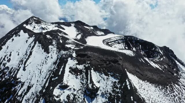 Aerial view, zooming in on the gases coming out the summit of the active tungurahua volcano in the Andes of Ecuador, South America