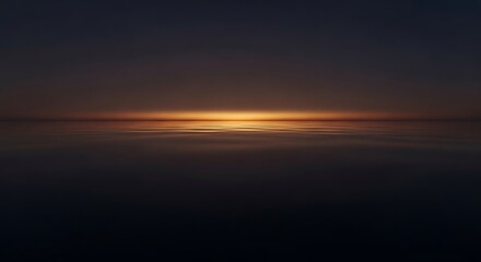 Fototapeta premium Dark ocean water with a vibrant orange sunset on the horizon line
