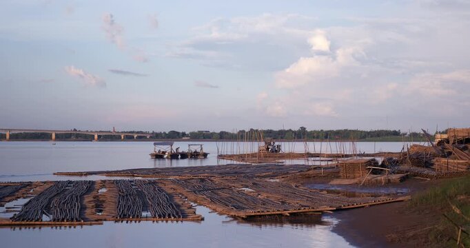 close up of view of pre assembled sections for a future seasonal bamboo bridge floating on the Mekong River and stacked along the bank during construction in Kampong Cham