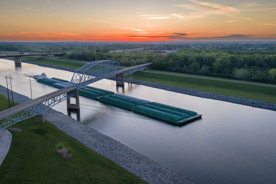 towboat with barges on Chain of Rocks Canal of Mississippi River above St Louis - aerial view before sunrise