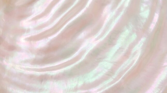 Mother of pearl texture with soft pink iridescent glow