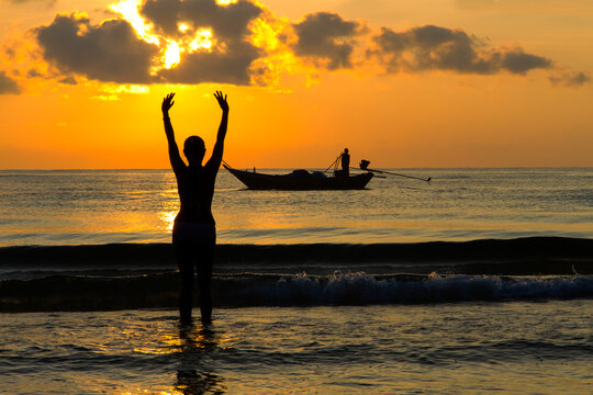 Woman enjoy with sunrise and silhouette