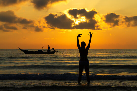 Woman enjoy with sunrise and silhouette