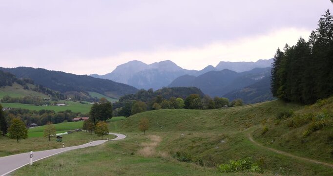 Scenic alpine landscape with a winding road in German Alps.