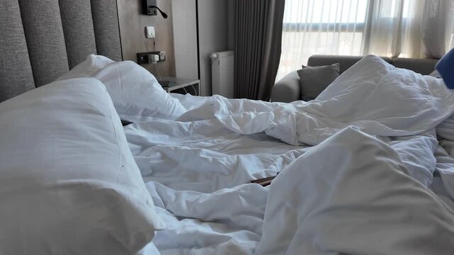 Morning routine in a hotel room with unmade bed