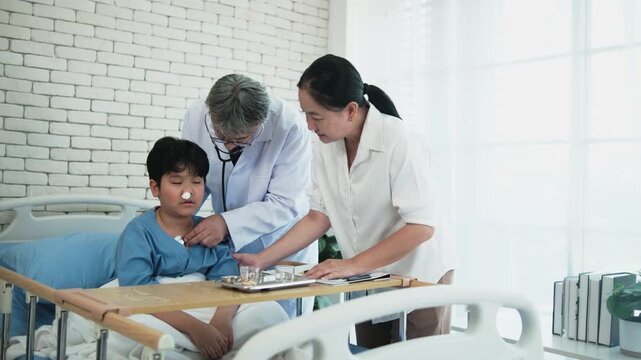 Professional White doctor visits, exams, and checkups sick Asian patient boy in pediatric hospital ward, child illness healthcare consultation and medic physician, diagnosis advice to parent worried.