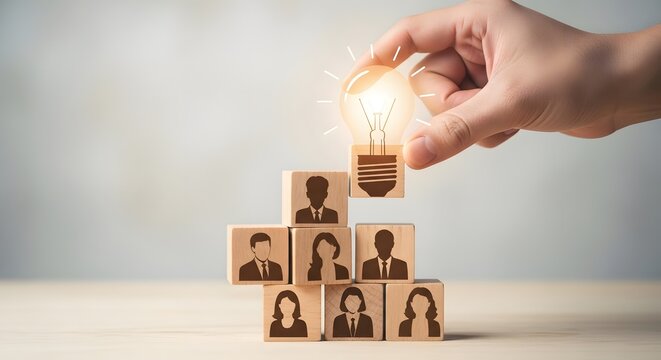 Hand placing lightbulb idea on teamwork blocks stack