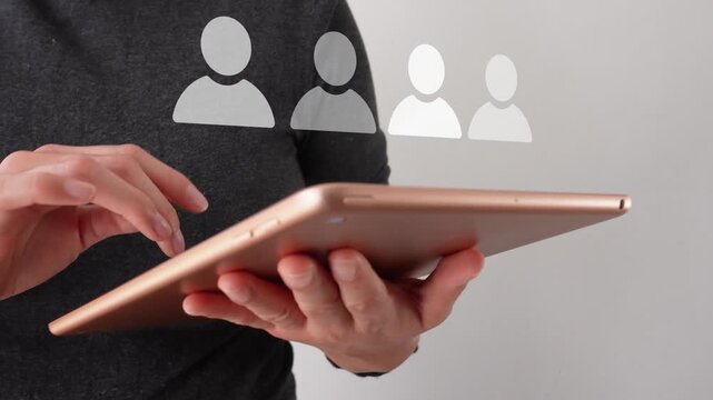 Close-up of a businesswoman interacting with her tablet. Animation of a row of avatars, where one stands out from the others. Indicates the correct personnel selection.