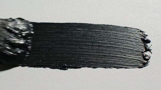 Black paint smear on textured surface perfect for UI/UX design and motion graphics