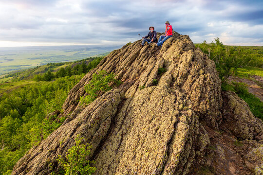happy mature married couple traveling through the Ural mountains on a summer day