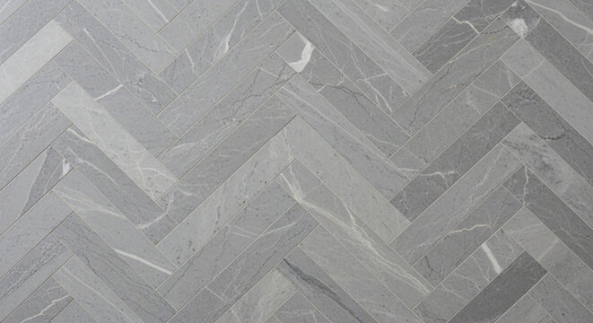 Elegant grey marble-effect ceramic tiles laid in a modern herringbone pattern perfect for luxurious flooring or sophisticated interior design backgrounds