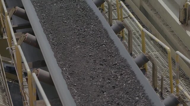 Industrial Conveyor Belt Transporting Raw Coal in Mining Facility