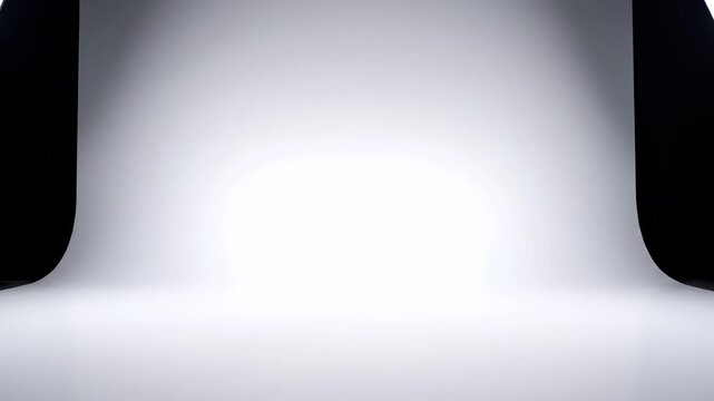 Empty professional photography studio setup with softbox lights and seamless backdrop, ideal for product placement and creative shoots