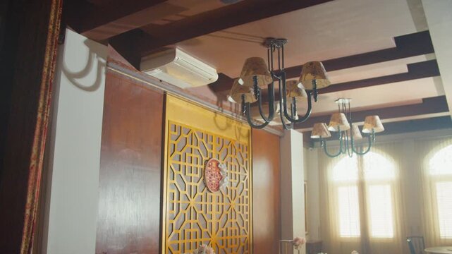 A beautifully decorated restaurant hall for a traditional Chinese engagement ceremony featuring elegant red floral arrangements, gift boxes, and cultural ornaments in a warm, festive atmosphere