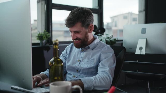 A dedicated and focused professional is working late into the evening at a modern office