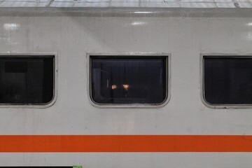 Train Windows And Orange Stripe On Retro Passenger Carriage © nsiswan