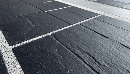 Fototapeta premium Black flagstone paving with grey terrazzo grout pattern, modern charcoal slate paving with speckled concrete joints.