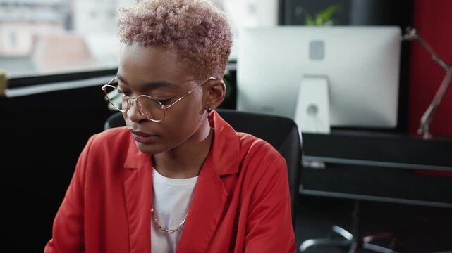 A dedicated and focused professional actively working at a computer in a modern office environment