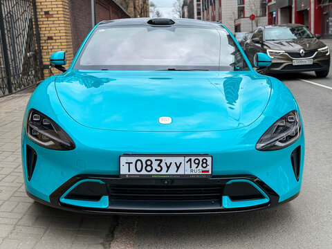 Xiaomi SU 7 MAX turquoise color parked at the city street side view. Exterior of a bluenXiaomi SU7 MAX Chinese electric car. A dynamic and intelligent electric car from China. 