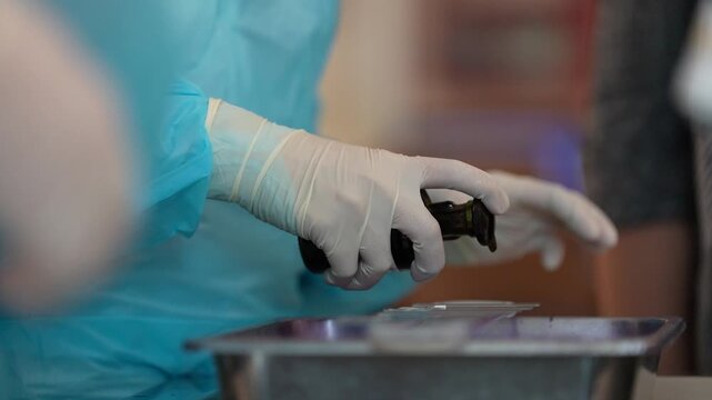 Gloved hand staining slide in laboratory sample research setting with glass slide and drop bottle, medical disinfectant sterile clinic scene with metal tray