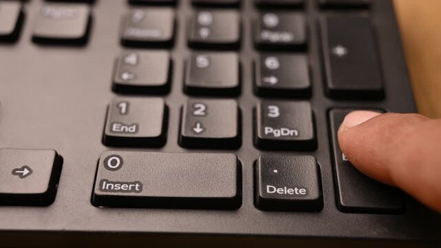 Overhead View of Man Pressing Enter Key on Keyboard for Command Execution