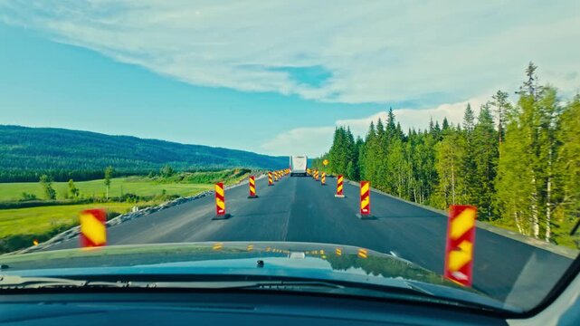 Driving Past a Stretch of Roadwork Lined With Cones and Open Countryside Views Along the European Route E6 North From Fosen in Tr&oslash;ndelag, Norway - POV Shot