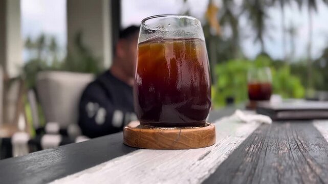 Fresh ice americano with blurr background of outdoor restaurant