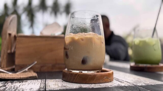 Tasty and fresh ice latte with blurr background of outdoor restaurant