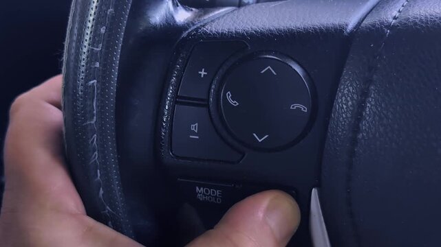 Button operation on car steering wheel for audio and phone functions
