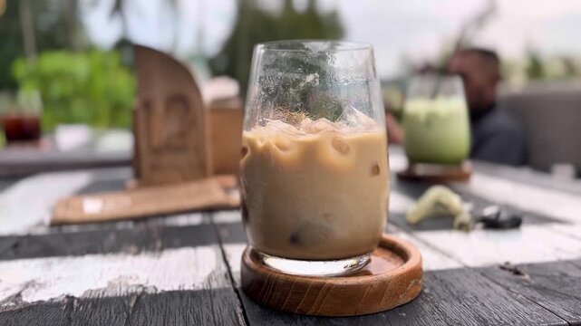 Tasty and fresh ice latte with blurr background of outdoor restaurant