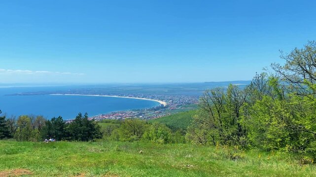 People Having Fun on Mountain Swing with Panoramic Sea and Coastal City View, 4K Horizontal