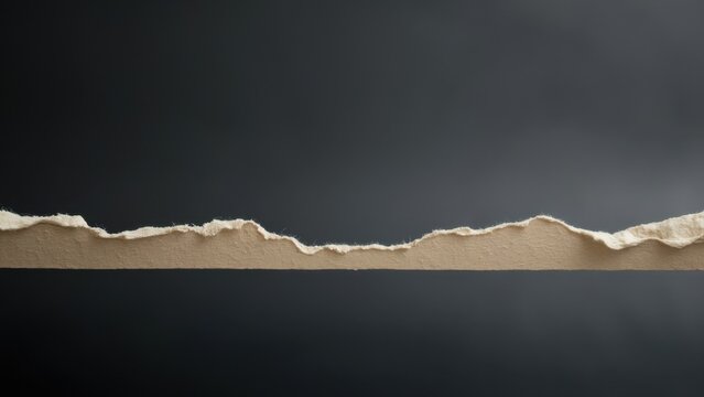 The image depicts a piece of paper with noticeable damage, including ripped edges and creases. The torn edge and cracks give the paper an aged appearance.