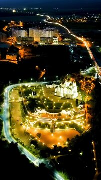 Vertical video. Gelendzhik, Russia. Cathedral of St. Andrew the First-Called. Andreevsky park. Night time. Drone footage, Departure of the camera. Rich colors