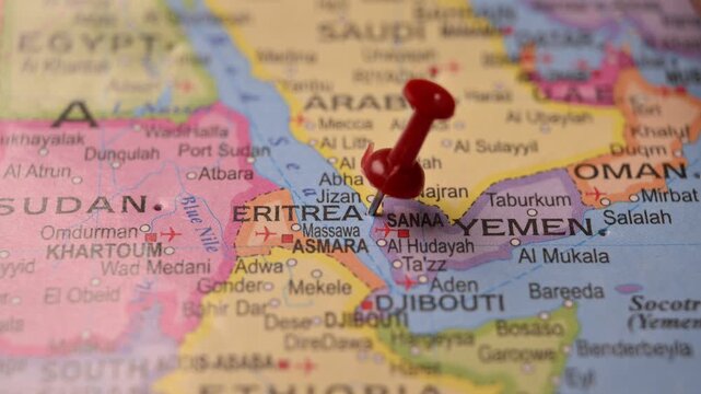 Hand Pointing Eritrea with Red Pin on World Map 4K 60fps Close-Up Shot