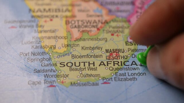 Hand Pointing South Africa with Green Pin on World Map 4K 60fps Close-Up Shot