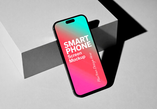 Modern Smartphone Screen Mockup Leaning on Geometric Block with Sharp Shadows and Colorful Gradient Display