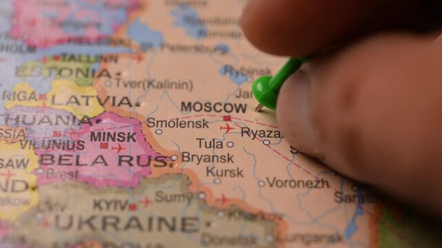 Hand Pointing Moscow Russia with Green Pin on World Map 4K 60fps Close-Up Shot