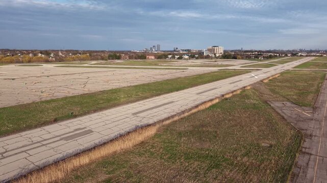 Aerial footage showing the circular concrete tie-down pads and weathered runway of the closed Buttonville Municipal Airport in Markham, Ontario, capturing a unique pattern of urban decay
