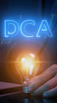 DCA, Dollar cost averaging concept. Investment strategy, Regular investment, Saving stock or savings on a monthly, quarterly basis. Businessman holding lightbulb to show DCA icon with investment graph