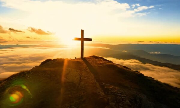 a wooden Christian cross placed prominently on a mountaintop.